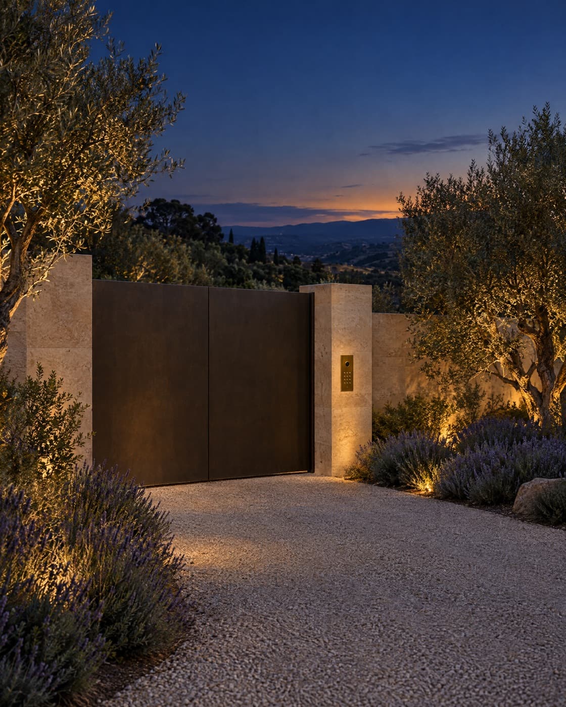 A private estate gate with a discreet call box at dusk